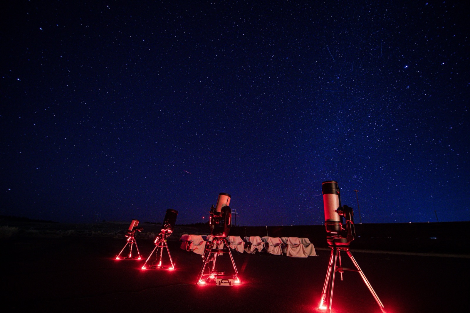 Telescopes set up in a field under the stars near Bryce Canyon